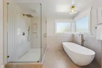 19 _ 3208 Camino Colorados _ Bathroom with a glass shower, soaking tub, and windows