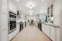 11 _ 4022 Happy Valley Road _ Kitchen with white cabinetry and stainless steel appliances