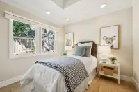 24 _ 4022 Happy Valley Road _ Bedroom with twin-size bed and framed artwork