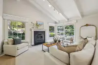16 _ 4022 Happy Valley Road _ Living Room with fireplace, seating area, and large windows