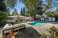 18 _ 4022 Happy Valley Road _ Backyard with swimming pool, seating area, and outdoor cabana