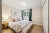 22 _ 4022 Happy Valley Road _ Bedroom with floral bedding and closet doors