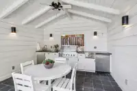 30 _ 4022 Happy Valley Road _ Guest house outdoor kitchen with dining area