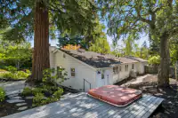 33 _ 4022 Happy Valley Road _ Guest house exterior with landscaped grounds and deck area