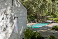 34 _ 4022 Happy Valley Road _ Guest house exterior with outdoor shower and pool area