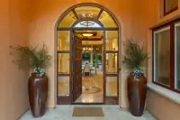 7 _ 24 Cosso Court _ Front entry with arched doorway and decorative planters