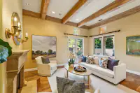 9 _ 24 Cosso Court _ Living room with fireplace, exposed ceiling beams, and seating area