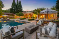 20 _ 24 Cosso Court _ Backyard poolside seating area with outdoor sofas and fire pit