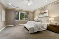 35 _ 24 Cosso Court _ King bed with upholstered headboard and window seating area
