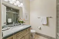43 _ 24 Cosso Court _ Green tiled vanity with glass-enclosed shower