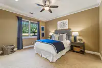 37 _ 24 Cosso Court _ Bedroom with blue bedding and gray upholstered headboard