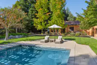 46 _ 24 Cosso Court _ Pool with paved deck, lounge chairs, umbrella, and landscaped backyard
