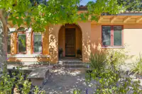 47 _ 24 Cosso Court _ Front entry with brick walkway, arched doorway, and landscaped garden