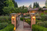 56 _ 24 Cosso Court .001 _ Gated entrance with brick walkway and landscaped hedges
