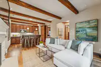 49 _ 24 Cosso Court _ Family Room with sectional seating, exposed ceiling beams, and open kitchen