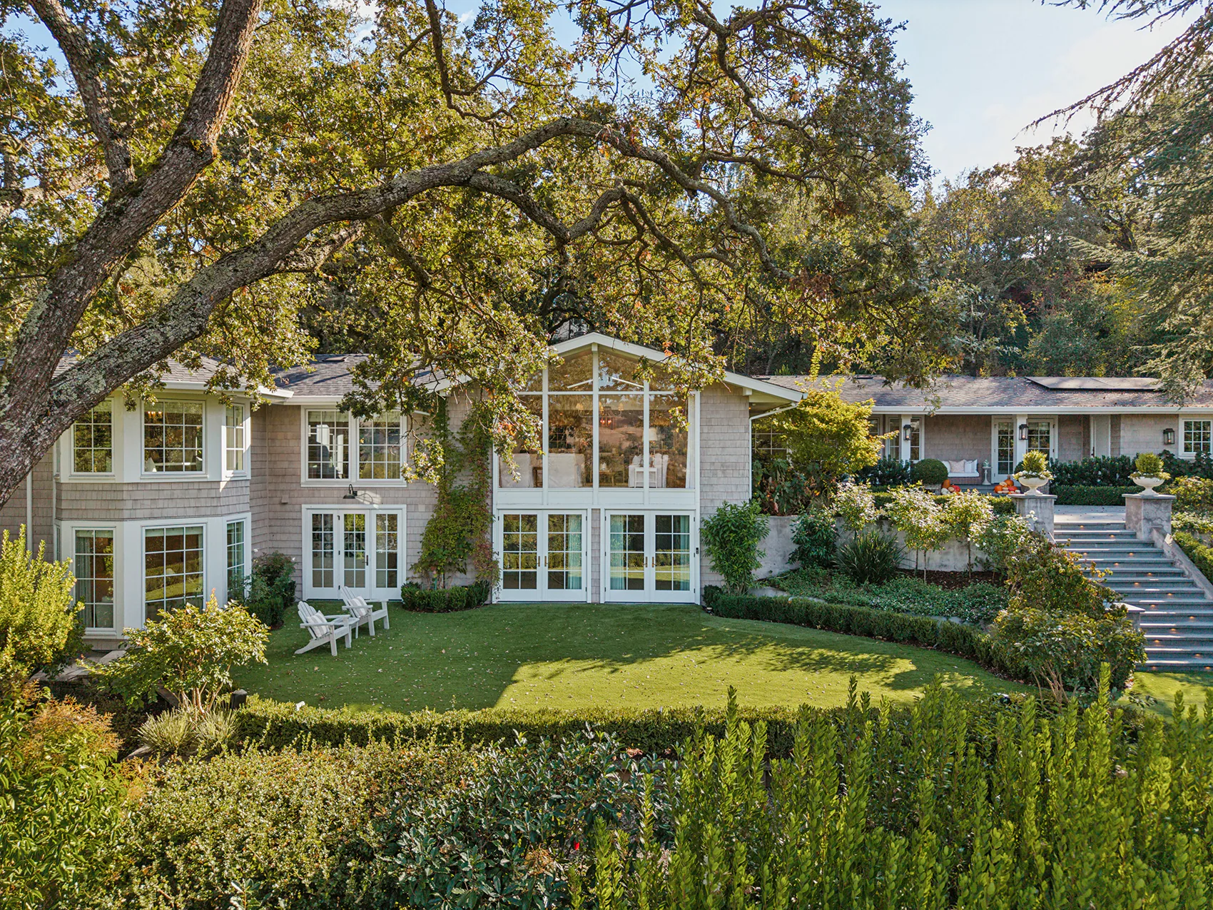 1 _ 800 Solana Dr - Exterior view of the house with landscaped yard and multiple French doors