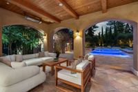 Patio w_white sofa --to pool at night